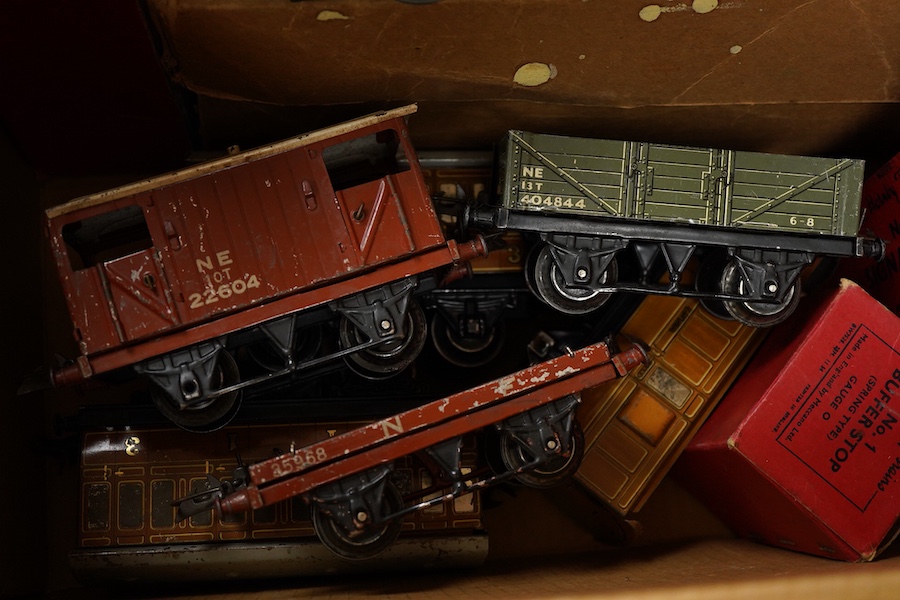A collection of Hornby clockwork tinplate 0 gauge railway, including; two LNER 0-4-0 tender locomotives, both 1842, (No.501), together with six 4-wheel wagons and coaches, a boxed No.3 Station, level crossing, signal cab
